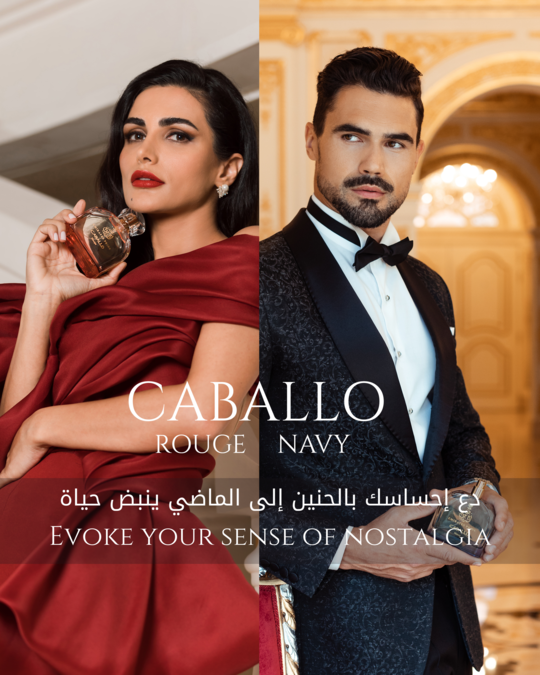 Models holding Emirates Pride Caballo Rouge and Navy perfumes