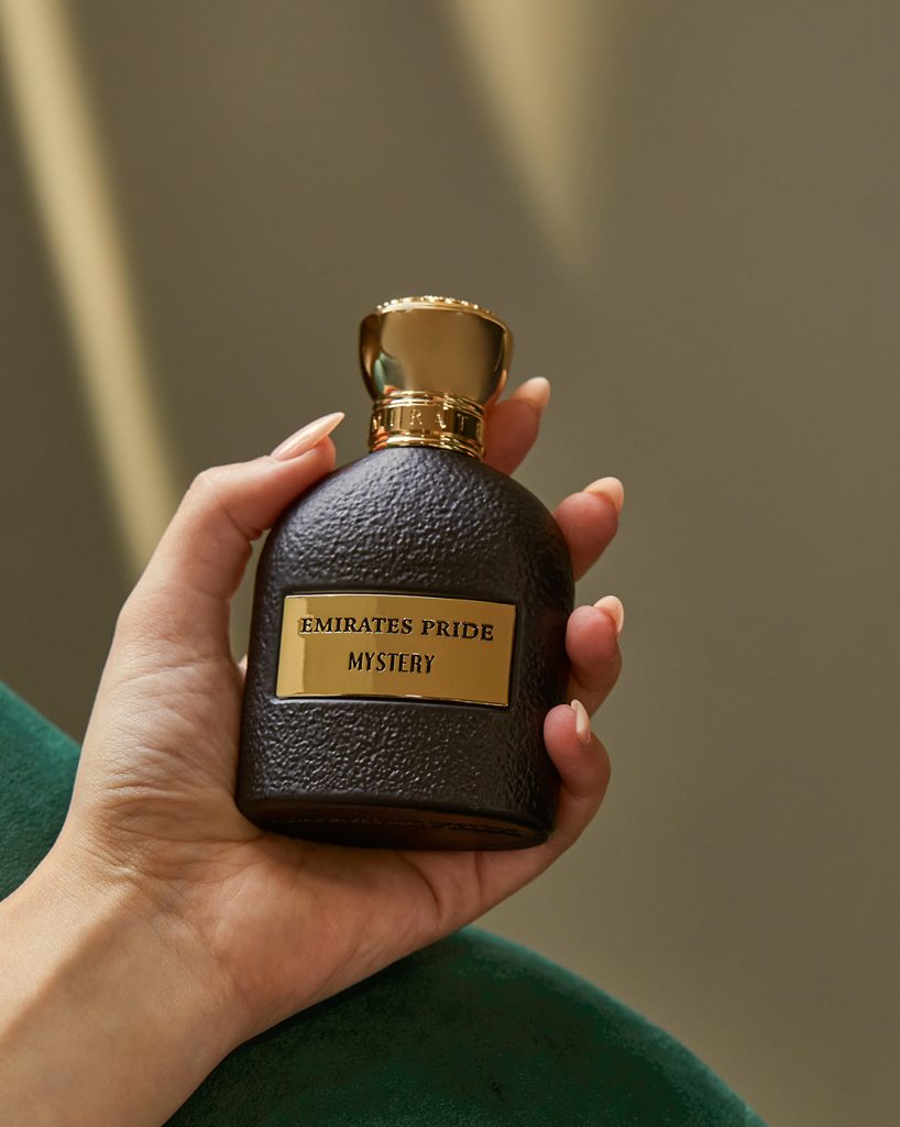 hand holding Emirates Pride Mystery perfume bottle